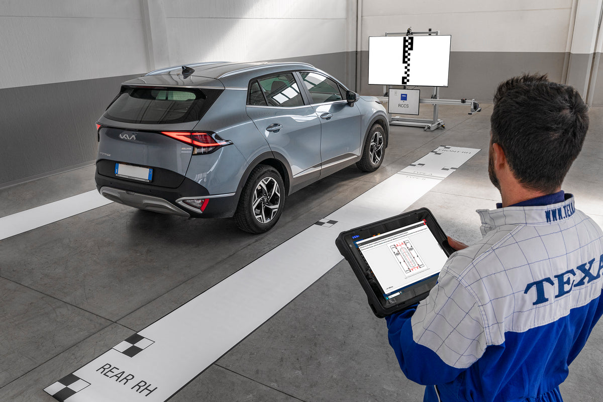 Technician working on KIA calibration with mats for 360.